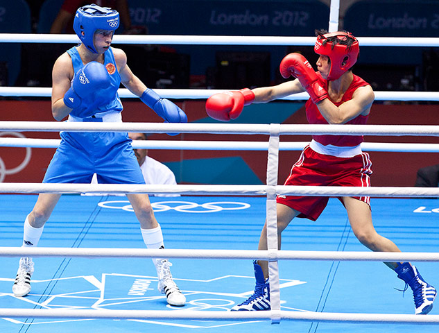 Women's boxing: Ren Cancan of China in Red and Elena Savelyeva of Russia scope each other