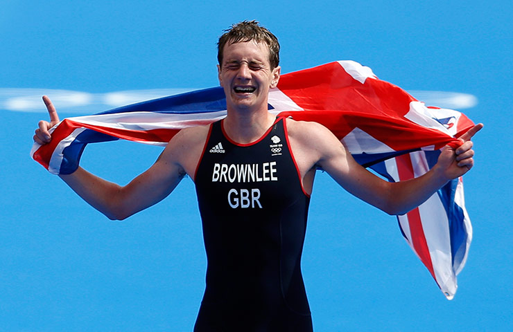 medal: Alistair Brownlee reacts as he crosses the finish line 