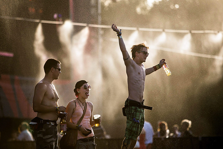 24 hours in pictures: Revellers cool off under water vapour at 20th Sziget Festival Begins