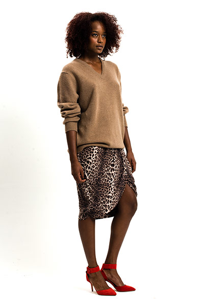 All Ages: Leopard: Model wears a leopard print skirt and a camel jumper and red shoes