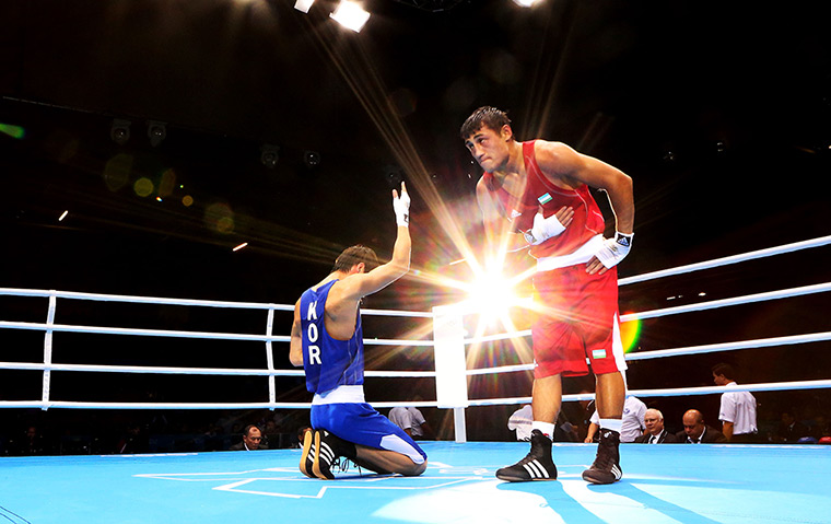 Winners and losers: Han Soonchul celebrates his victory over Fazliddin Gaibnazarov at boxing