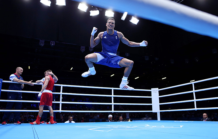 Winners and losers: Anthony Ogogo celebrates after beating Ukraine's Ievgen Khytrov