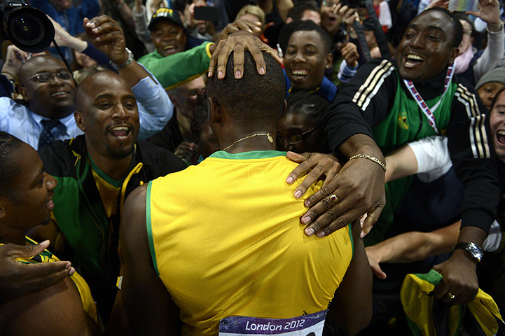 Winners and losers: Jamaica's Usain Bolt celebrates after winning the men's 100m final