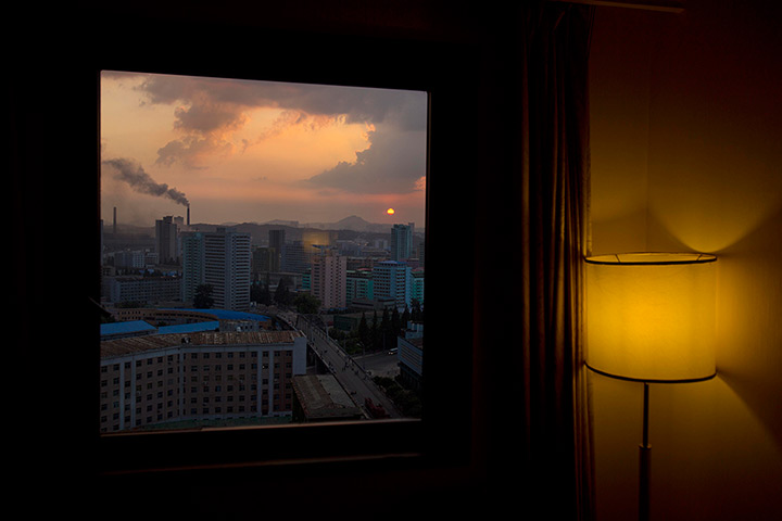 24 hours: Pyongyang, North Korea: The sun sets over the city, seen from a hotel room 
