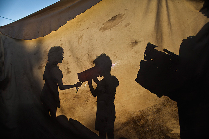 24 hours: Gaza Strip: The shadow of a Palestinian refugee girl drinks water