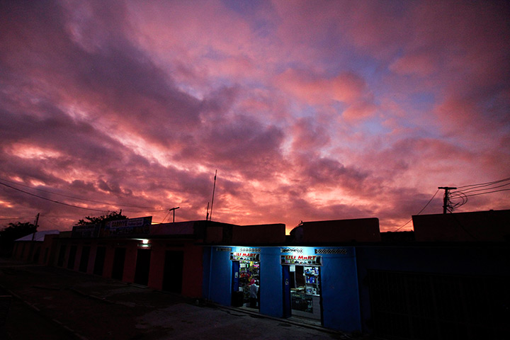 24 hours: Mogadishu, Somalia: A lone shop on an empty street at dusk 