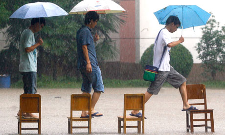students walk in flood water