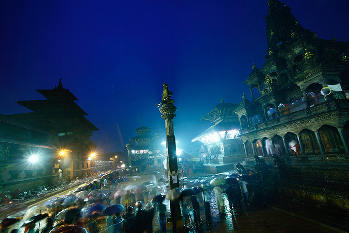 24 hours: Lalitpur, Nepal: Devotees stand in a queue in front of the Krishna Temple