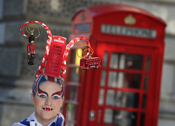 24 hours: London, England: A woman wears a hair sculpture depicting a phone box