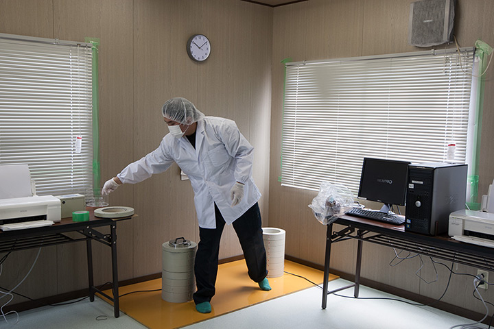 Soma, Japan: At the seafood radiation testing centre, Haga Noriaki conducts checks