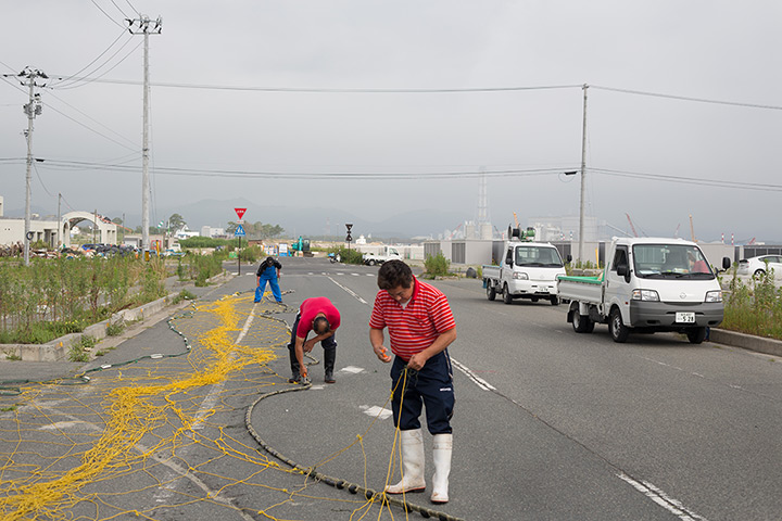Soma, Japan: Fishermen mend their nets in the Matsukawaura district of Soma
