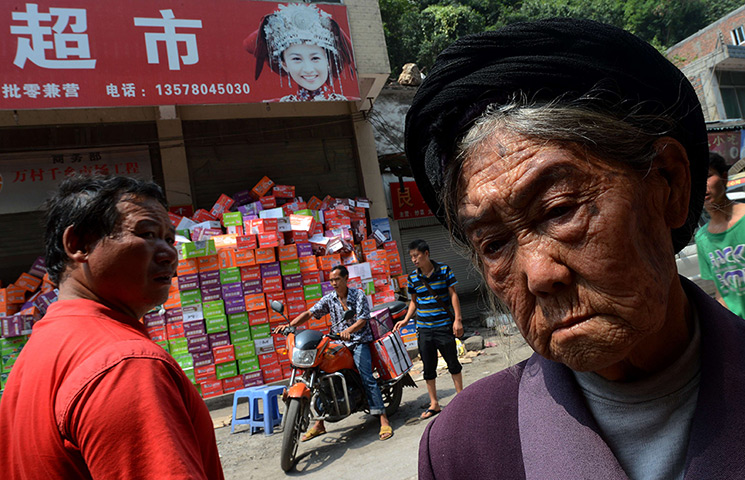 24 hours: Yiliang County, China: An elderly villager at a food distribution centre