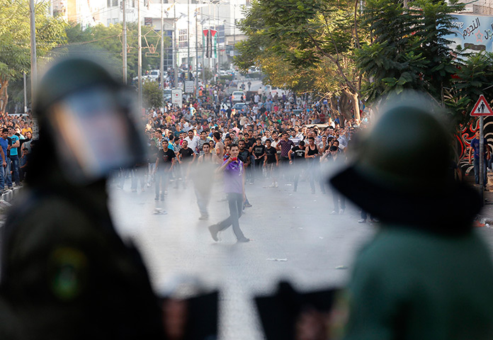 24 hours: Hebron, West Bank: Palestinian security officers in front of protesters