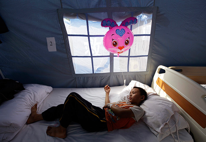 24 hours: Yiliang, China: A quake survivor rests after receiving medical treatment