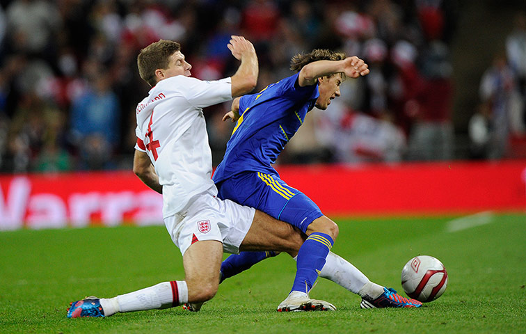 england versus ukraine: Steven Gerrard lunges at the ball through Denys Garmash
