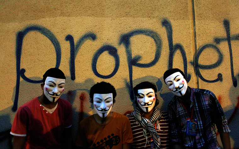 Benghazi protest: Egyptian protesters wearing Guy Fawkes masks pose 