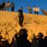 Benghazi protest: Protesters climb down from the wall of the US embassy in Cairo 