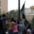 Benghazi protest: Egyptian protesters raise a black flag inside the US embassy