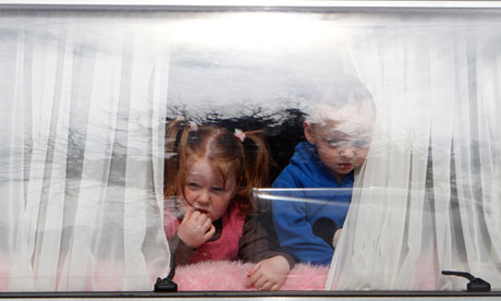 Children look out of caravan window at Dale Farm