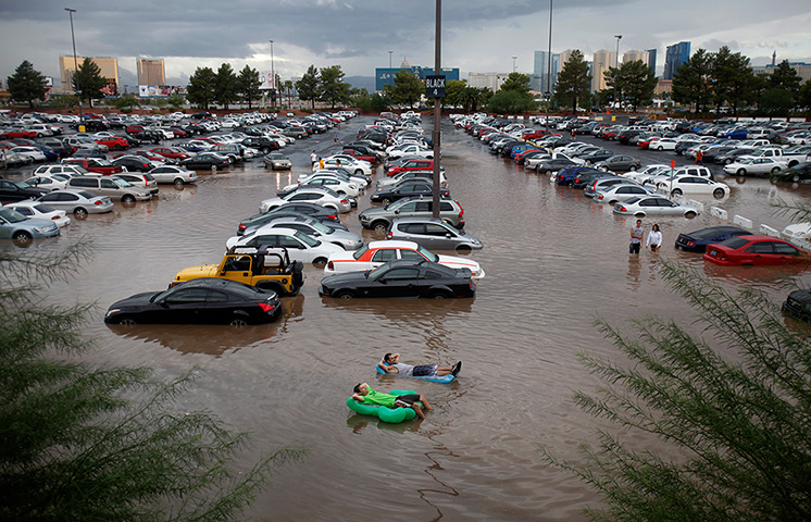 24 hours: Las Vegas, California, USA: Students relax on inflatables in floodwater 