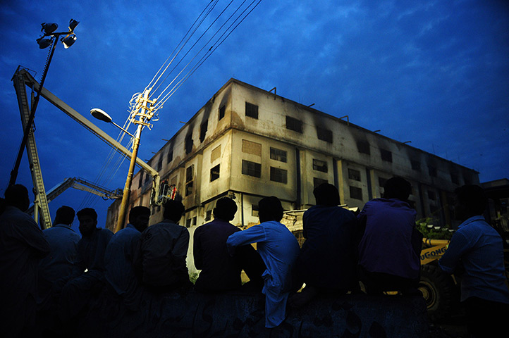 24 hours: Karachi, Pakistan: Residents watch a rescue operation at a garment factory