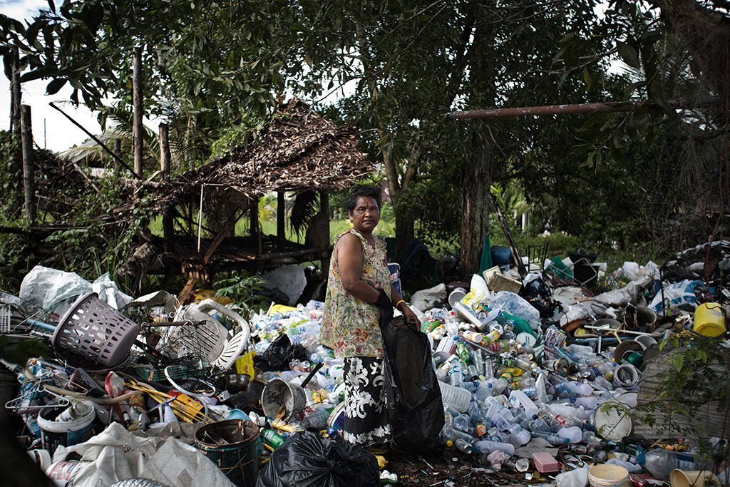 A Moken woman scavenges for recyclables