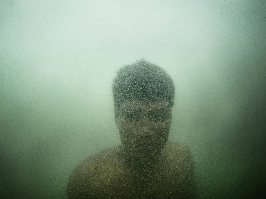 A Moken fisherman diving for razor clams