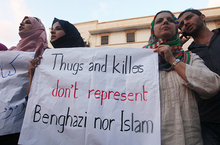 Libya protests: Demonstrator hold a placard during a rally to condemn the attack