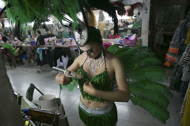 24 hours: Chiang Mai, Thailand: A ladyboy dancer takes a glue gun to her bra 