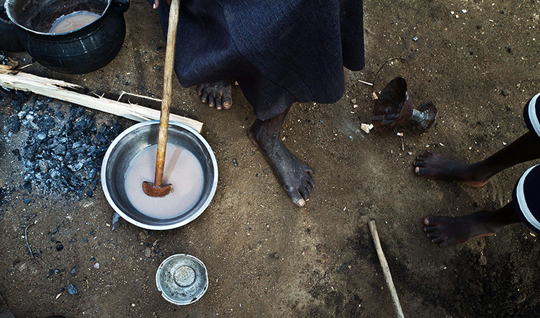 24 hours: Juba, South Sudan: A young South Sudanese girl prepares breakfast