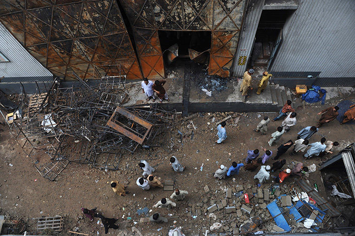 24 hours: Karachi, Pakistan: People gather in front of a garment factory