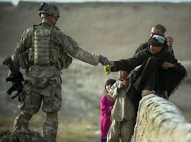 24 hours: Kandahar, Afghanistan: US army soldier shares grapes with children