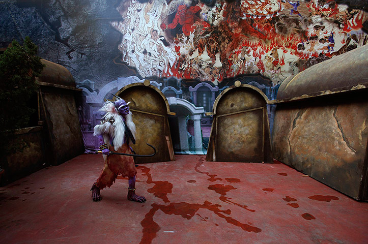 24 Hours: Hong Kong, China: An actor dressed as a ghost walks past '5D haunted house'