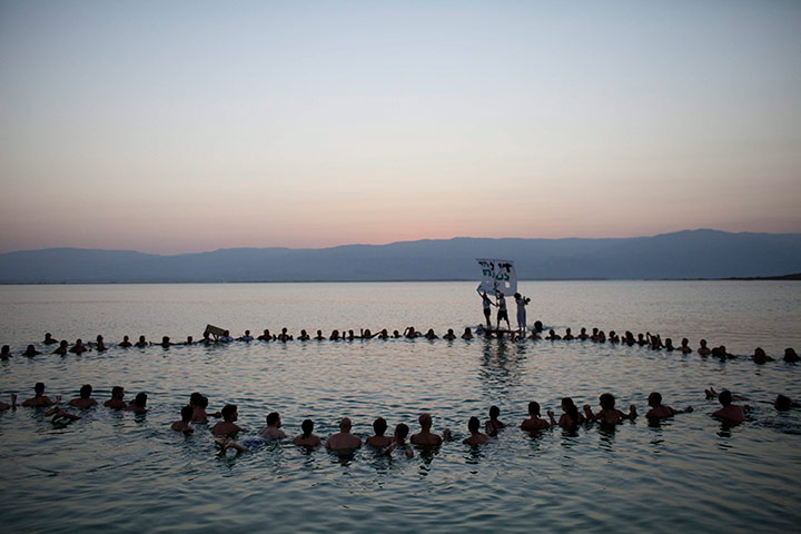 24 Hours: Ein Bokek, Israel: Swimmers float in the waters of the Dead Sea