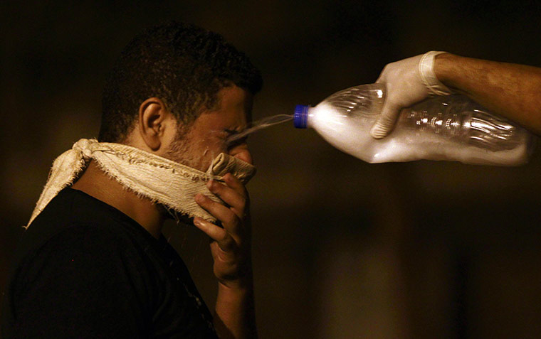 20 photos: A protester has his eyes doused with milk after tear gas was fired in Cairo