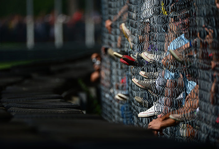 Best of the week: Fans climb onto a fence at the Autodromo Nazionale circuit 