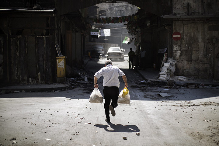 24 Hours: A Syrian man carrying grocery bags dodges snipers