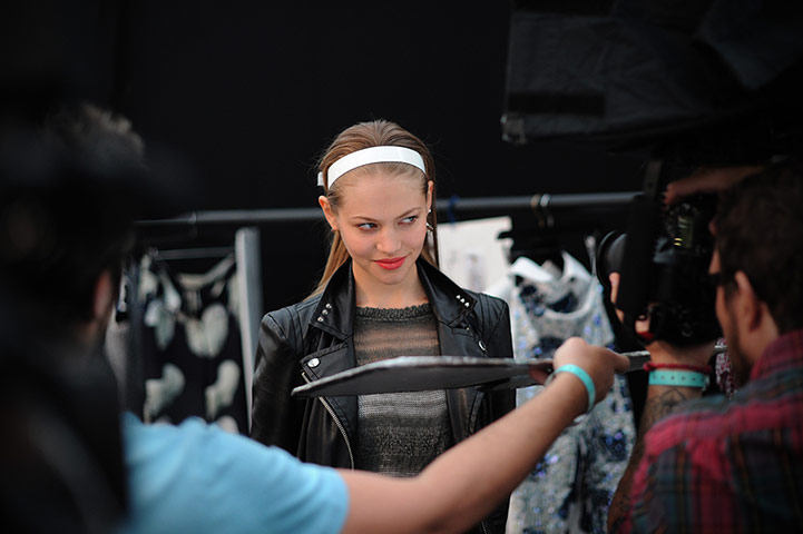 Fashion day 4: A model is photographed backstage before