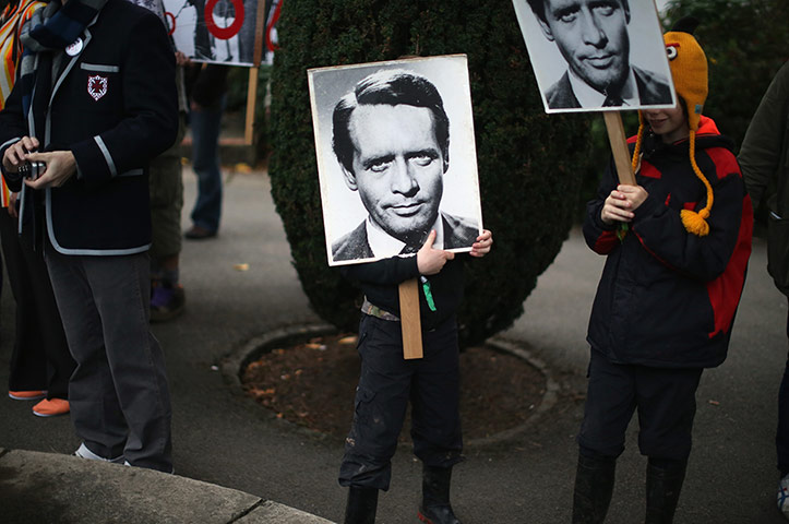 Festival No 6: Festival goers carry posters of Patrick McGoohan