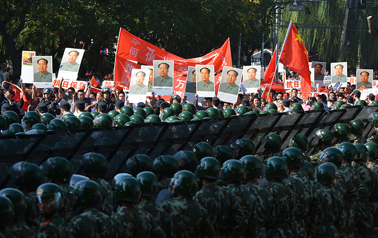 Anti-Japan protests: Demonstrators march holding images of fo
