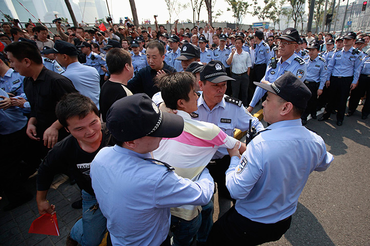 Anti-Japan protests: Policemen arrest a protester at the Bund in Shanghai