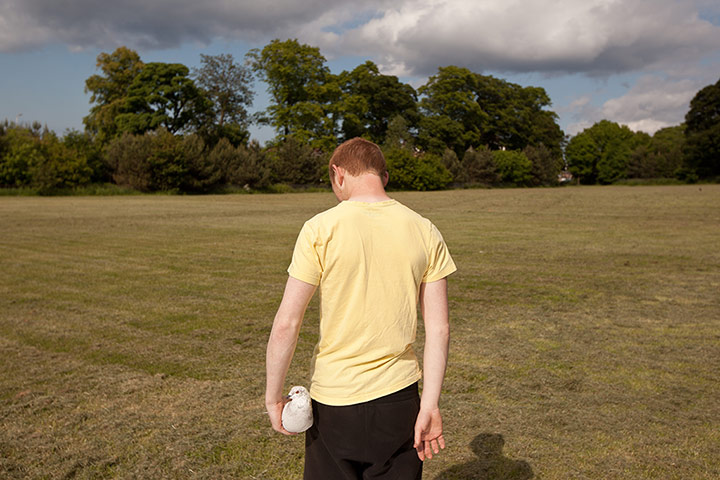 Scottish pigeons: An unidentified doomen stands with one of his birds