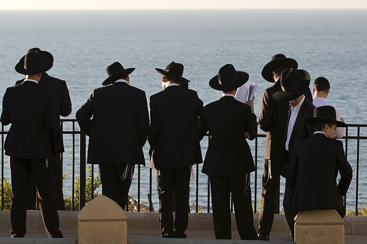 24 hours: Netanya, Israel: Ultra-Orthodox Jewish men read the Tashlich