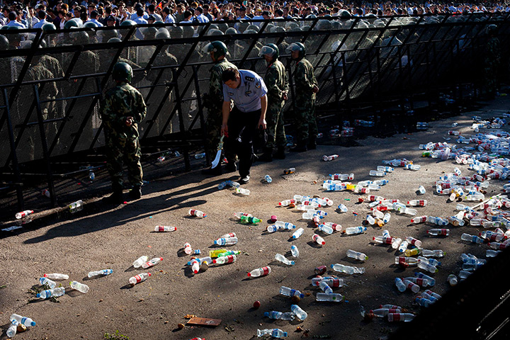 24 hours: Beijing, China: A policeman runs for cover