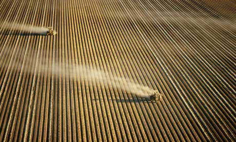Tractors ploughing vast field