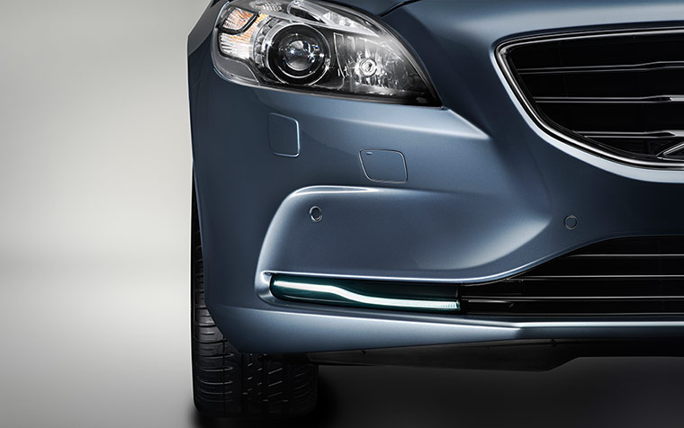 External view of blue Volvo V40 headlights and front bumper