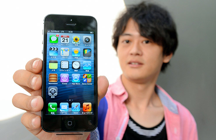 iPhone 5 on sale: Tokyo, Japan: A man poses with an iPhone 5