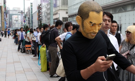 A man wearing a Steve Jobs mask waits in line outside the Apple store as the iPhone 5 smartphone goes on sale in Tokyo.  