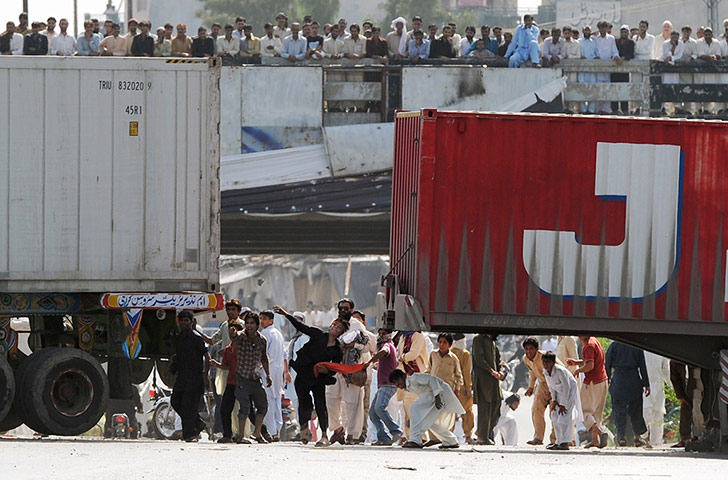 Film protests: Islamabad, Pakistan: Demonstrators throw stones towards the police