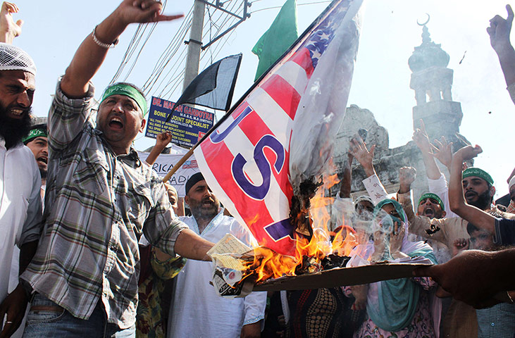Film protests: Jammu, India: A protester burns a US flag during a demonstration
